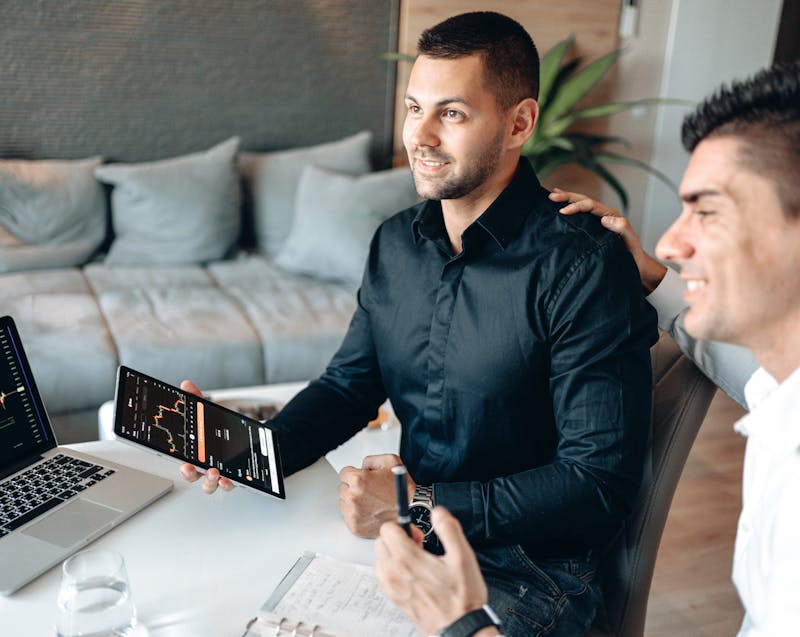 business partners looking at digital data